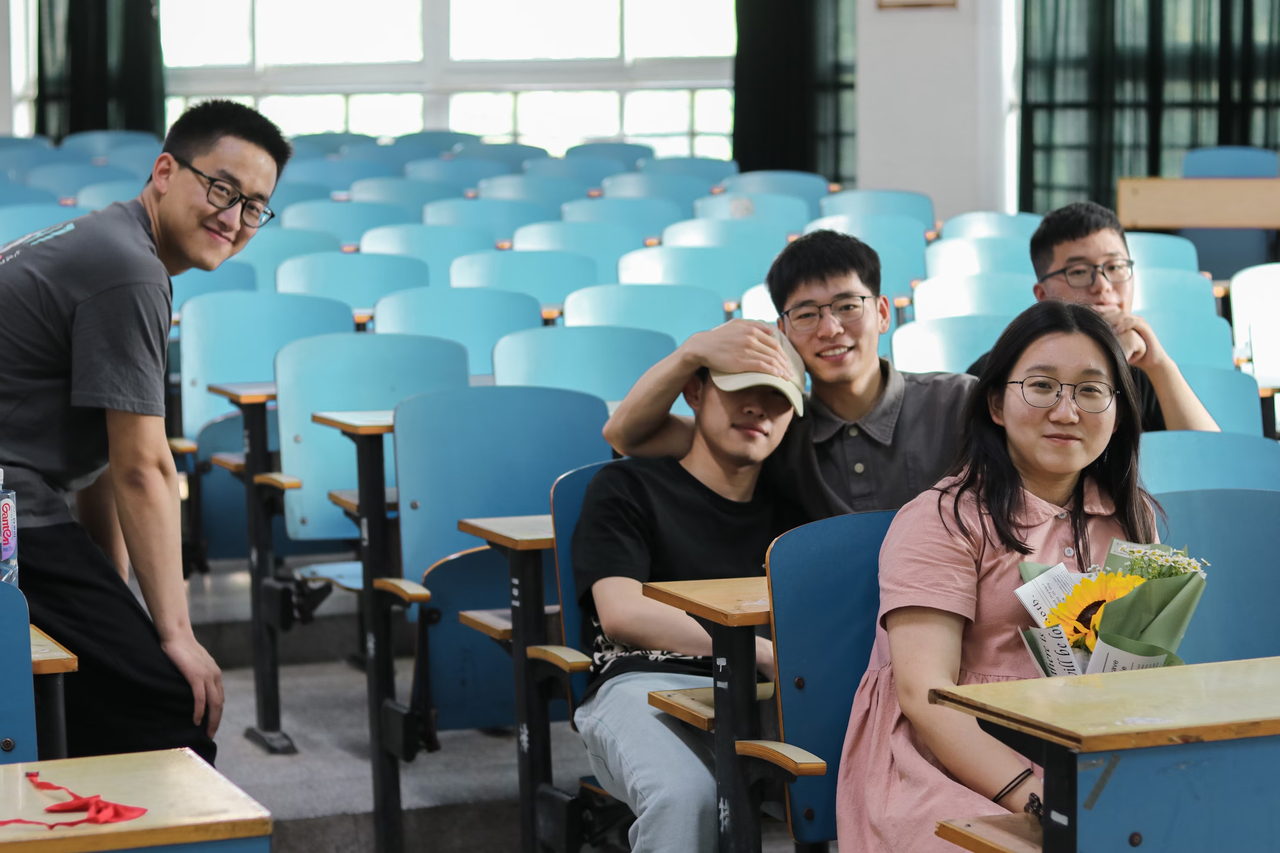A group of university students in a classroom
